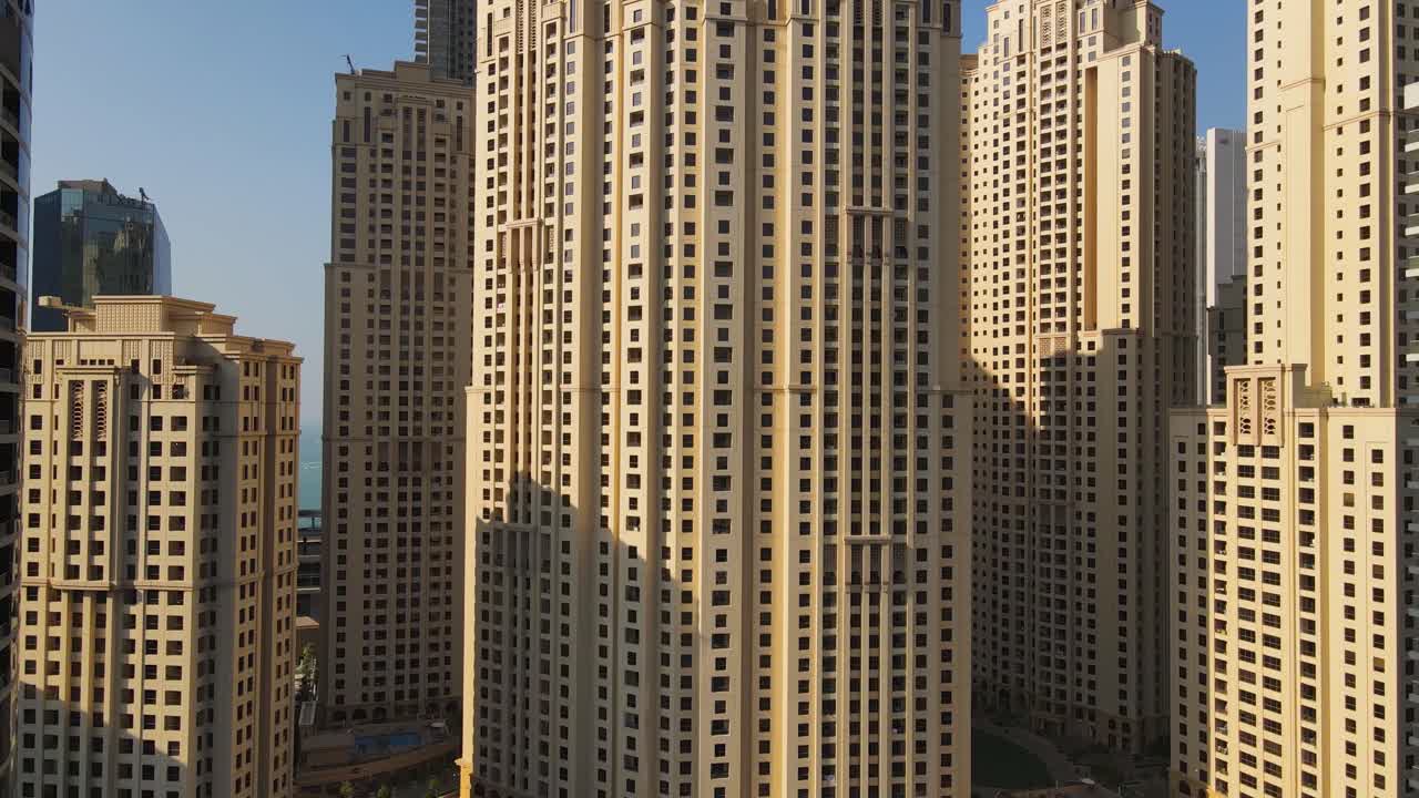 Aerial footage capturing stunning skyscrapers of Jumeirah Beach Residence showcasing impressive architecture and the vibrant urban landscape of one of Dubai's most popular waterfront communities