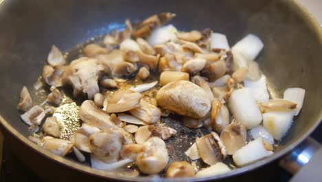 mushrooms and onions sautéing in a pan