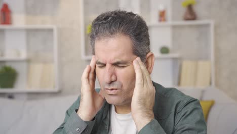 mature man with medical health problem has a headache.