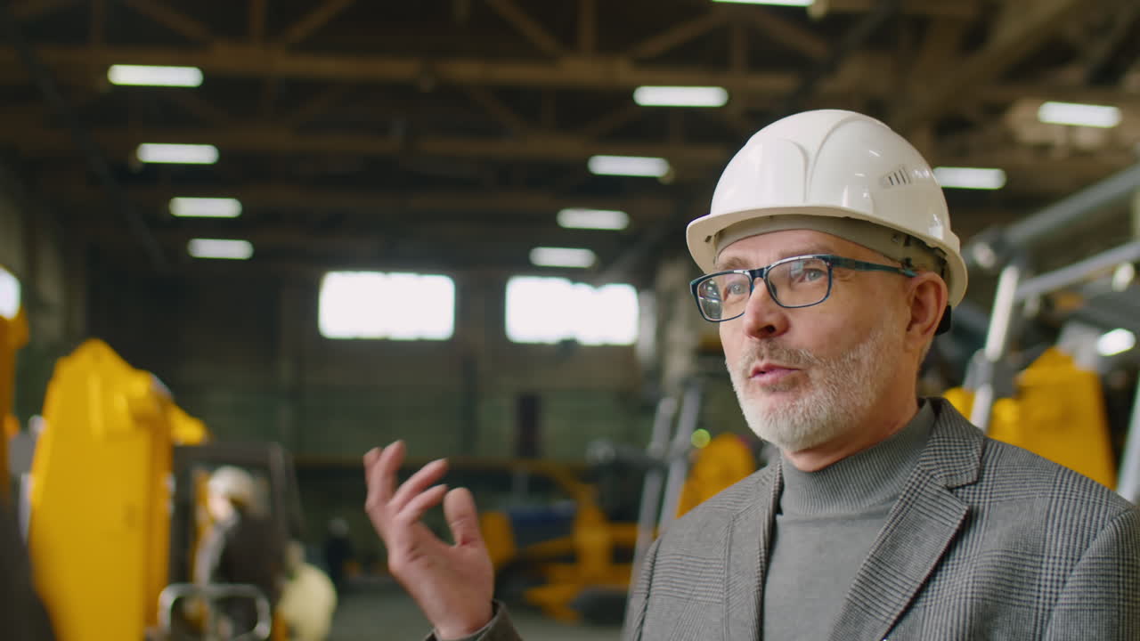 Senior Factory Engineer Speaking with Colleague