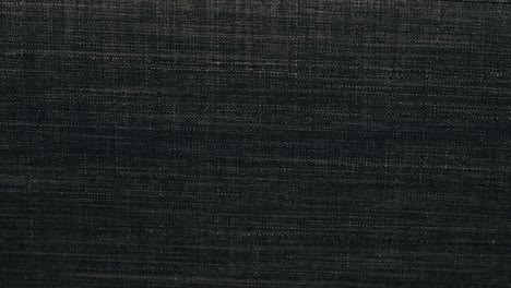 slow zoom in background back drop material organic large black grey charcoal threaded polyester cotton wool sofa couch arm texture soft luxurious warm stitched synthetic materials