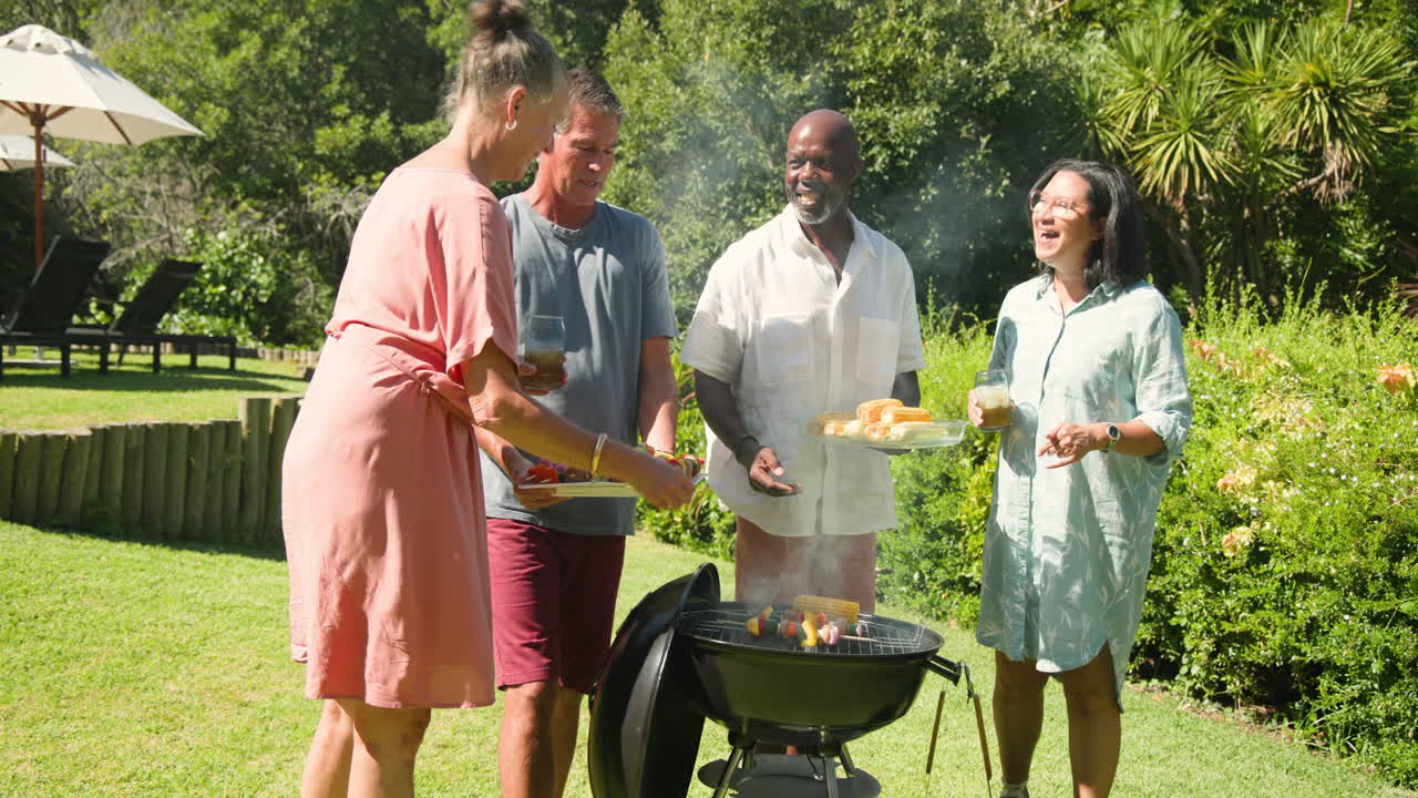 Grilling vegetables and corn on barbecue grill during sunny in garden gathering