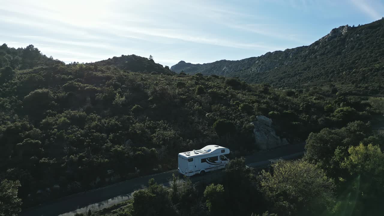 coche de campamento rv blanco, furgoneta de campamento conduce cuesta arriba montañas verdes, paisaje de valle en los pirineos verano, avión no tripulado aéreo establecimiento de tiro