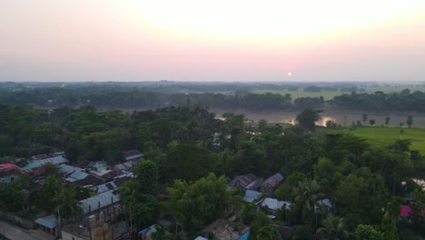 Small-village-slum-community-beside-river-at-sunrise-in-Asia