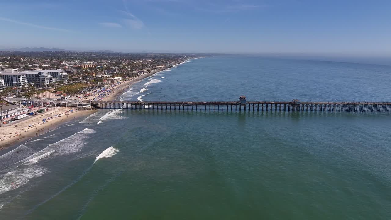 Trucking left shot of the Oceanside Ca Pier.
