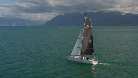 aerial of people relaxing on a boat while sailing on a beautiful lake