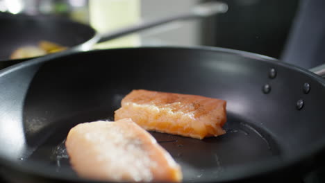 salting fish fillet on frying pan