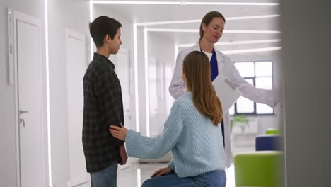 doctor consults with family in hospital corridor