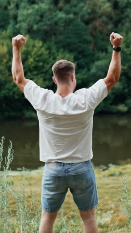 man enjoying nature by a river
