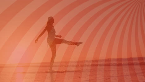 woman kicking ocean water on beach during sunset, showing radial stripe overlay health design