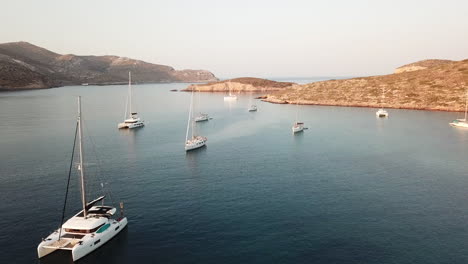 greece,leros island, archangelos bay, drone footage of the bay, footage moves towards the entrance of the bay, lot of sailboats and catamarans on anchor.footage ends at the boat where the drone lands