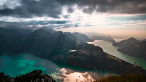 sunlight shines between breaks in clouds on top lake vierwaldstattersee of fronalpstock mountains switzerland