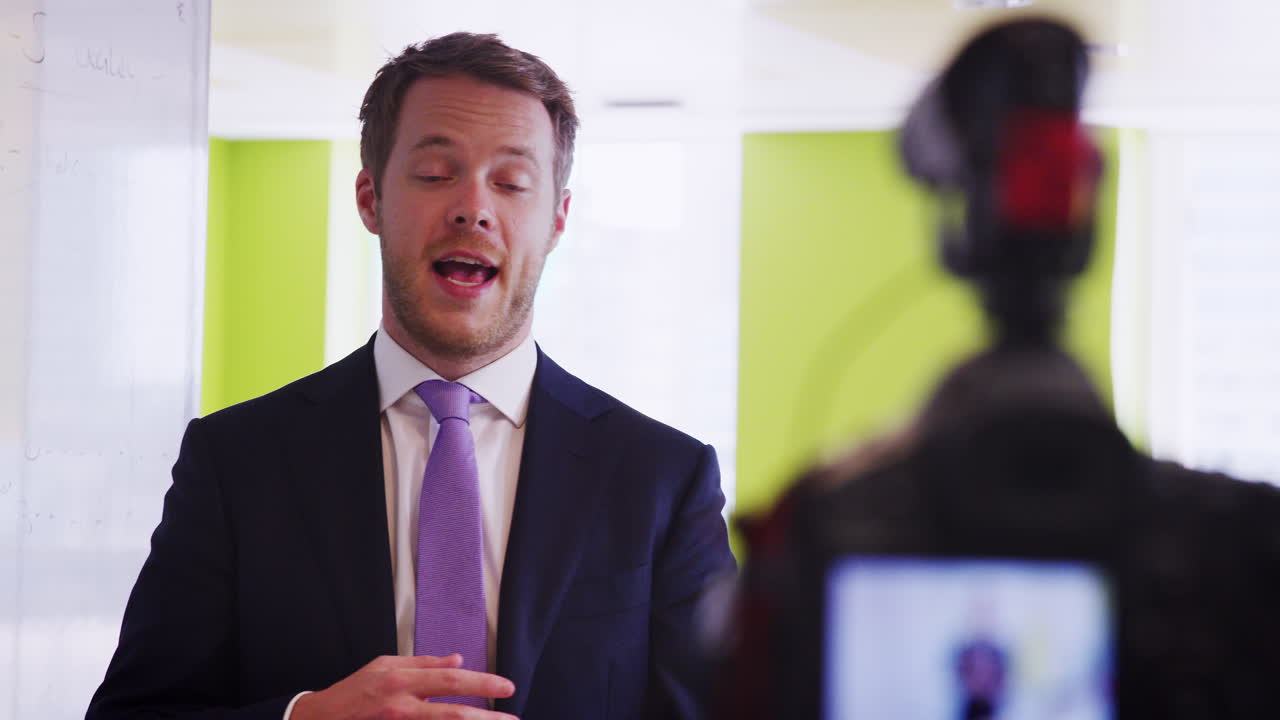 Young businessman making an instructional video