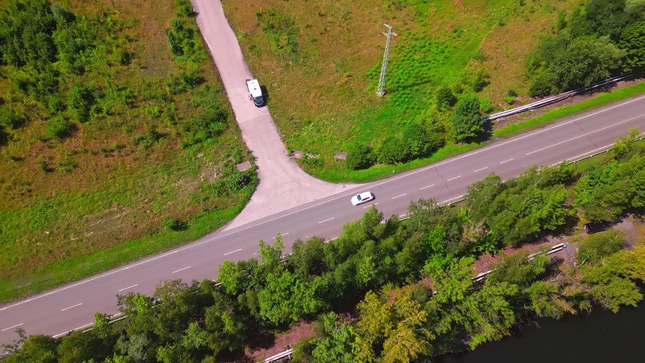 Drone reveals vehicles traveling along post Industrial mining landscape