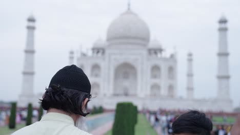 muslim man clicking pictures of taj mahal