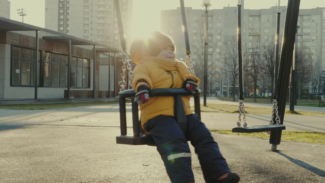 Child playing on a swing set in a park