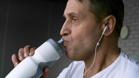 sportsman listening to music and drinking water