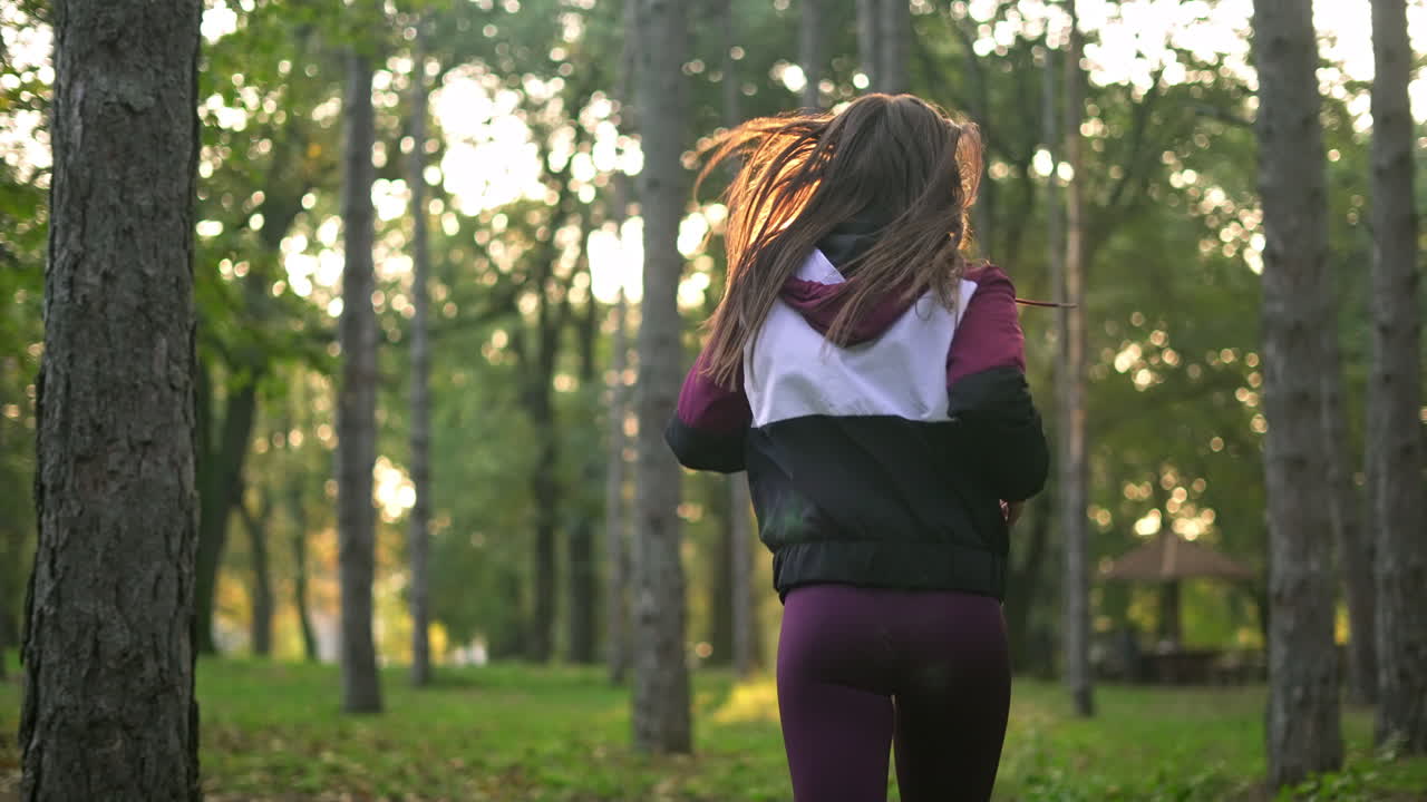 Woman jogging through a forest