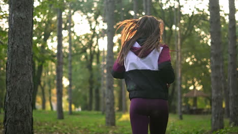 woman jogging through a forest