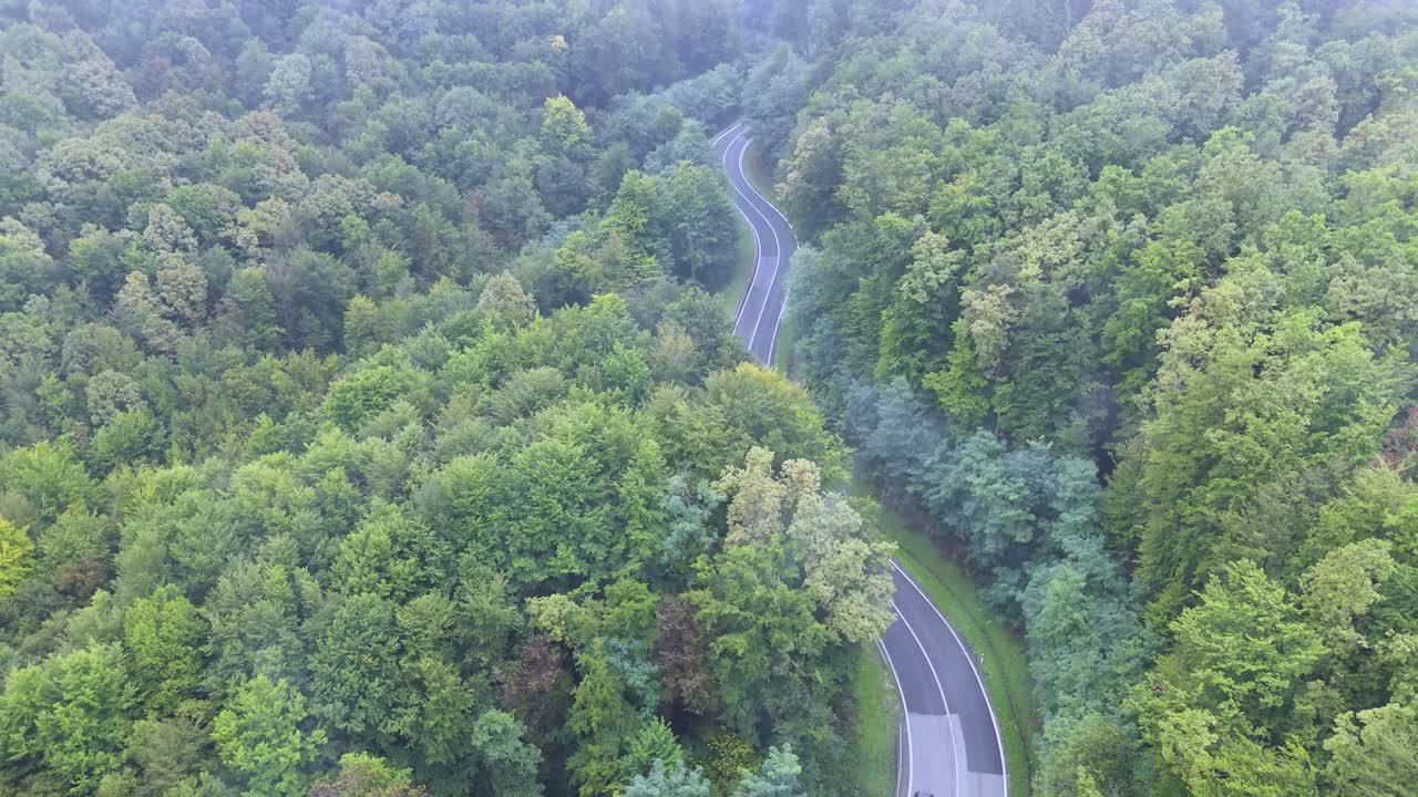Aerial View Of Electric Car Driving On Mountain Road - Drone Shot