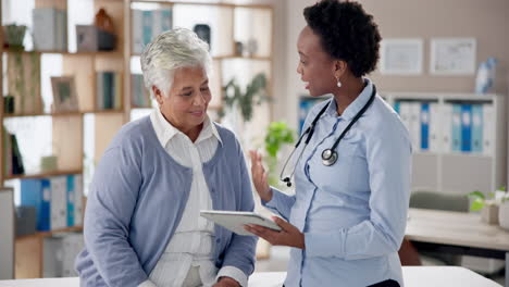 doctor consulting with elderly patient using a tablet