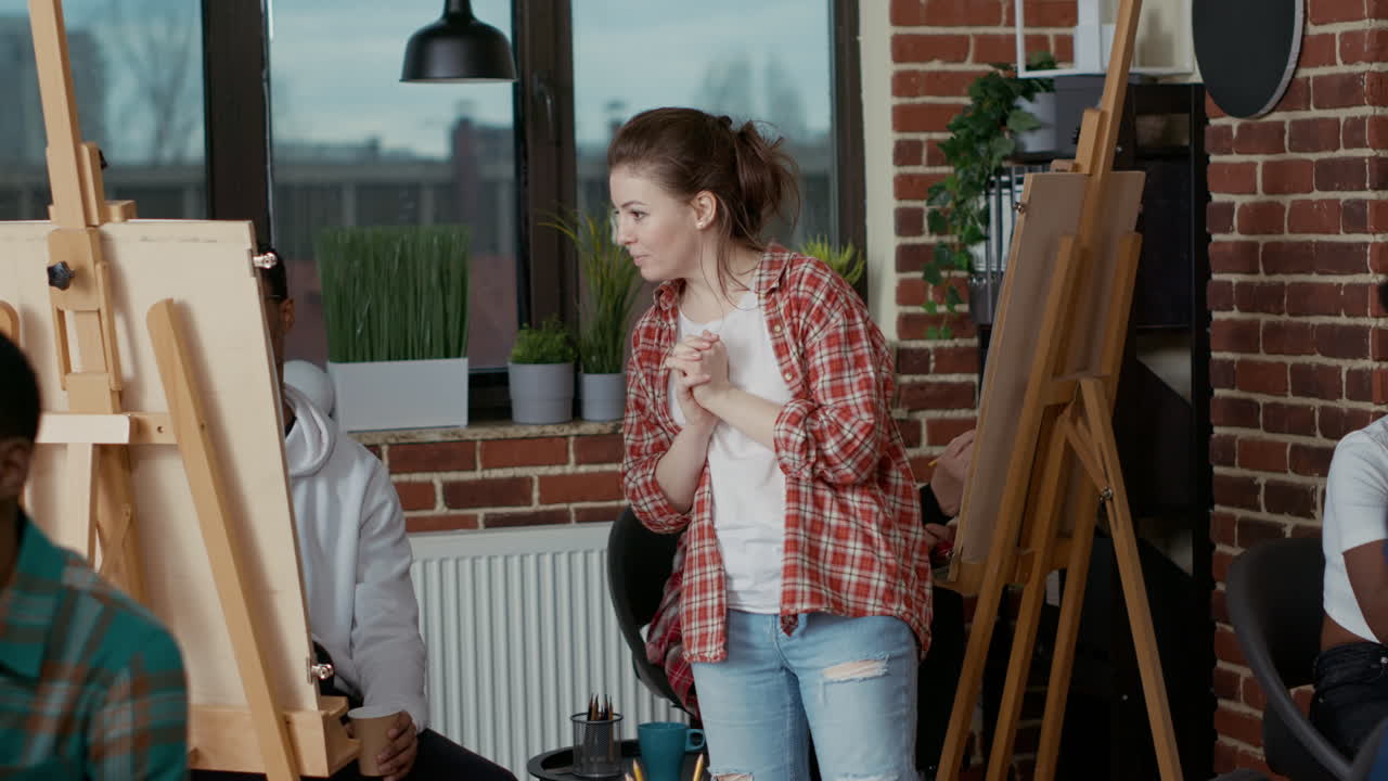 Young artist looking at people drawing sketch in art class program