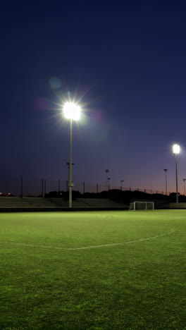 empty soccer field at night under lights
