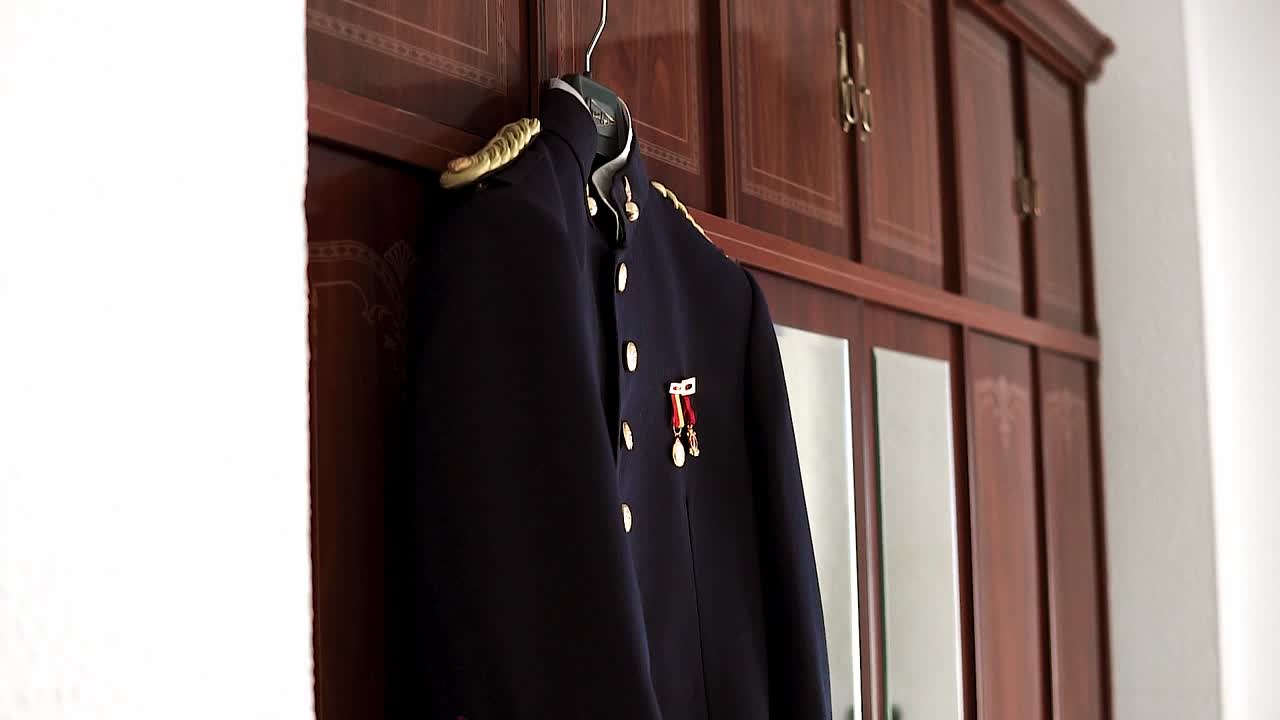 Slow revealing shot of the groom's military outfit for a wedding ceremony