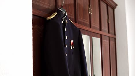 slow revealing shot of the groom's military outfit for a wedding ceremony