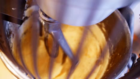 machine kneads fresh dough in bakery workshop closeup