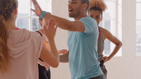 dance-class-happy-group-of-dancers-high-five-enjoying-successful-routine-resting-after-intense--training-practice-celebrating-achievement-in-studio