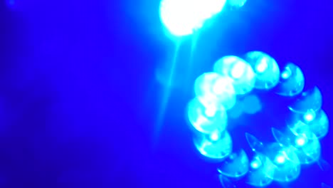 rolling kaleidoscope bokeh shot of blue spinning lights in a night club, hd 1080p, 59.94p b roll