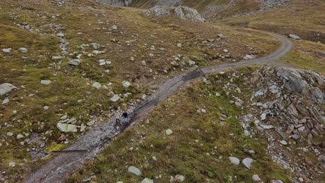 a stunning aerial footage captures the breathtaking swiss mountains and lago naret as two hikers venture through the scenic landscape