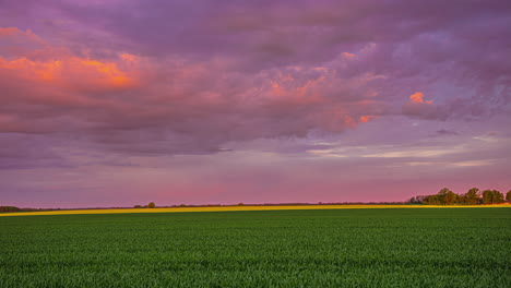 timelapse of clouds passing across sky over green farmland