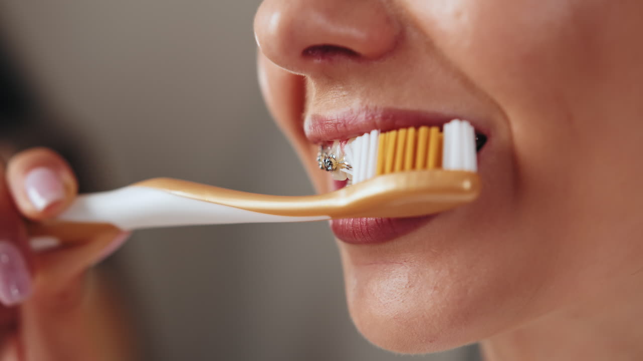 Woman Brushing Teeth with Braces