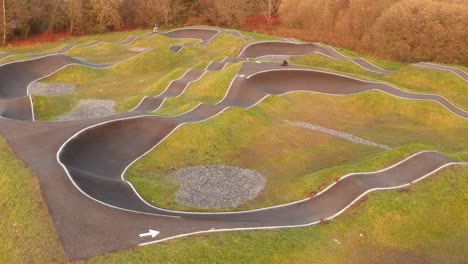 eboarder riding around a bmx pump track