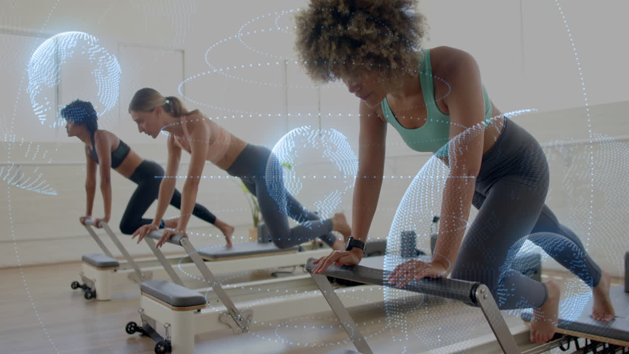 Women exercising on reformer machines with digital network animation overlay