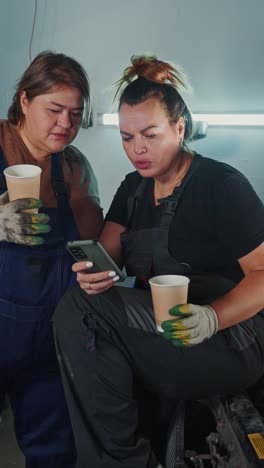 Women Mechanics Collaborating in a Garage