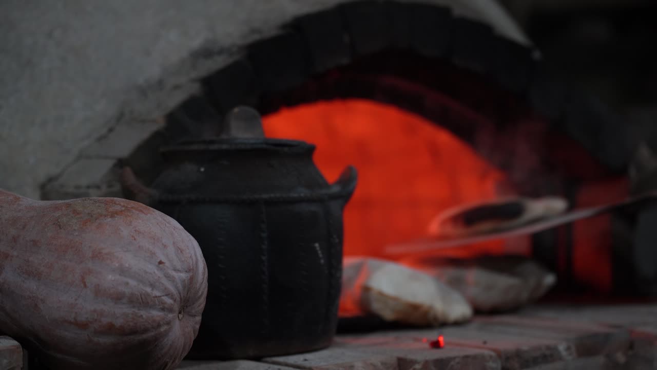 Bread Aromas: Baker's Shovel Reveals Freshly Baked Breads from Wood-Fired Oven in a Vintage Stone Hearth Setting, a Human Invention Delight