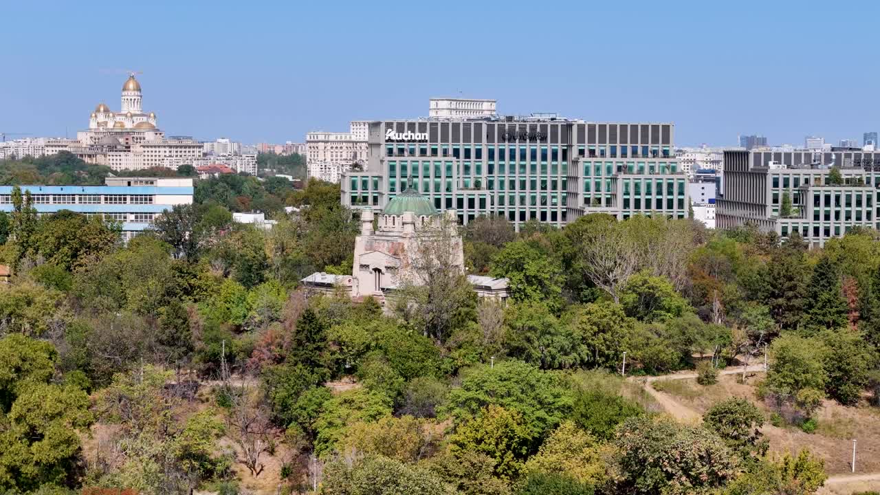 Rotating Aerial View Over Tineretului Park with the Crematorium and the Palace of the Parliament in the Background, Bucharest, Romania