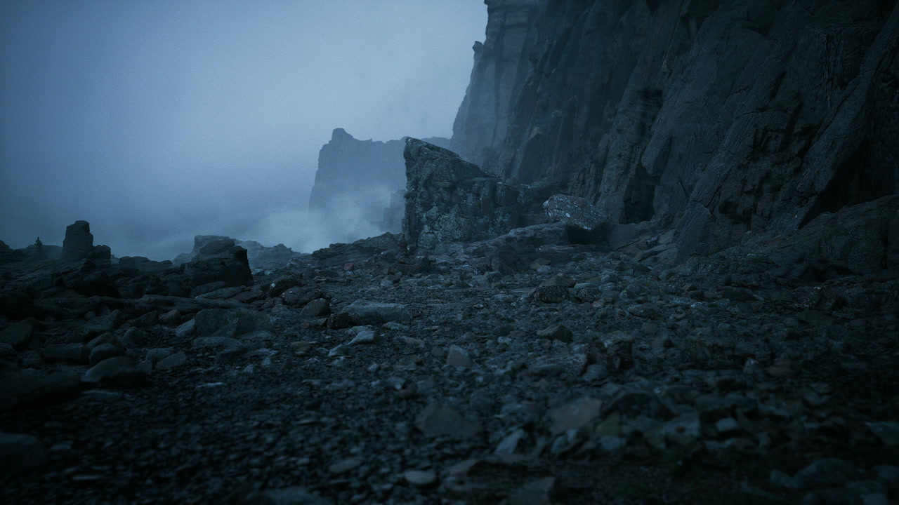 Field researcher explores jagged rocks along foggy shoreline at sunset