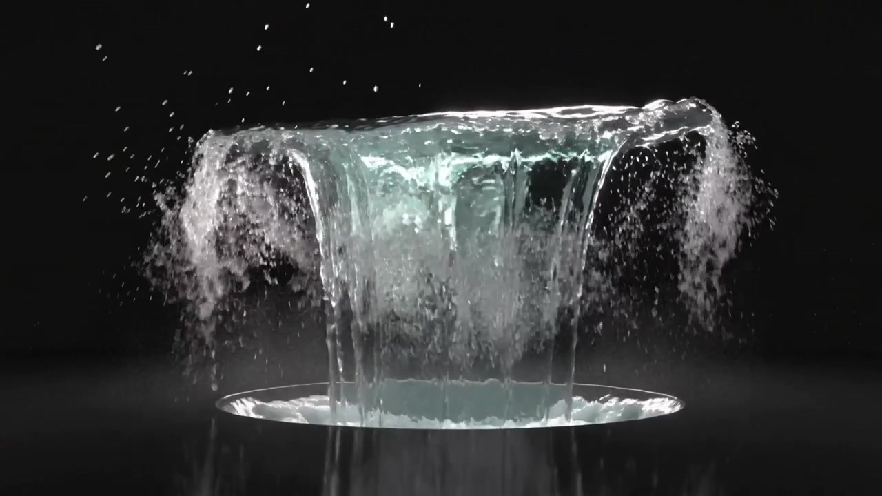 Un getto d'acqua verticale che emerge da un'apertura circolare, formando un velo circolare e rilasciando gocce.