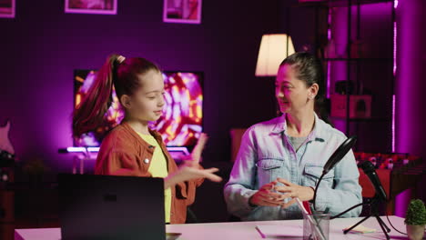 young girl teaching her mother how to do viral online dance moves while filming video