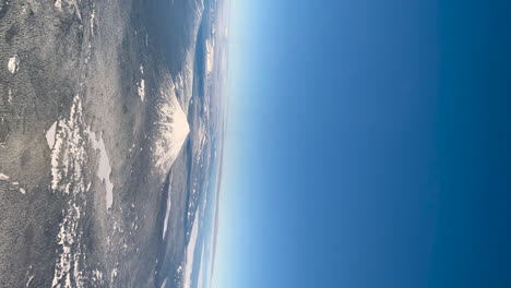 snow covered mountain stands out in the deep blue sky | vertical video