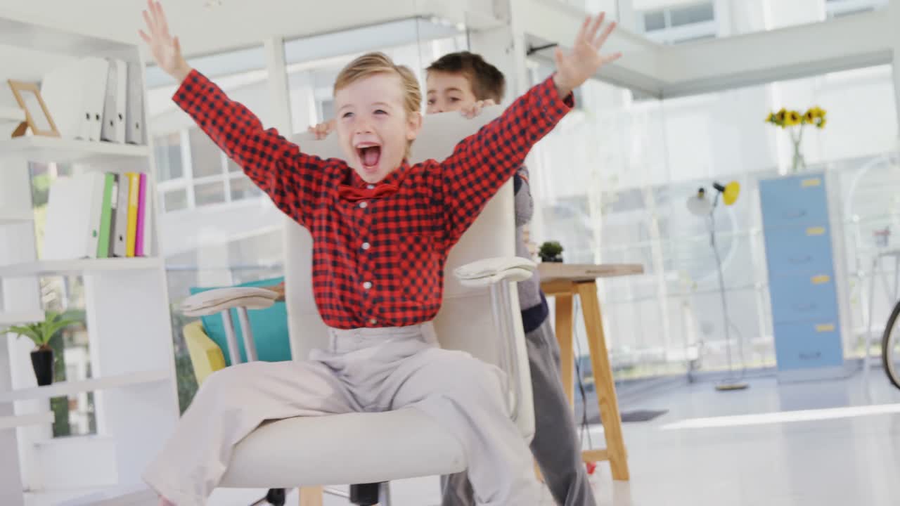 Boy as business executives pushing his colleague on chair 4k