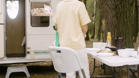 happy family having breakfast at the camping in the forest