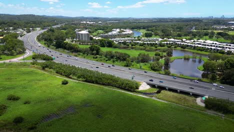 aerial over firth park, m1 and the glades, mudgeeraba, gold coast, queensland, australia