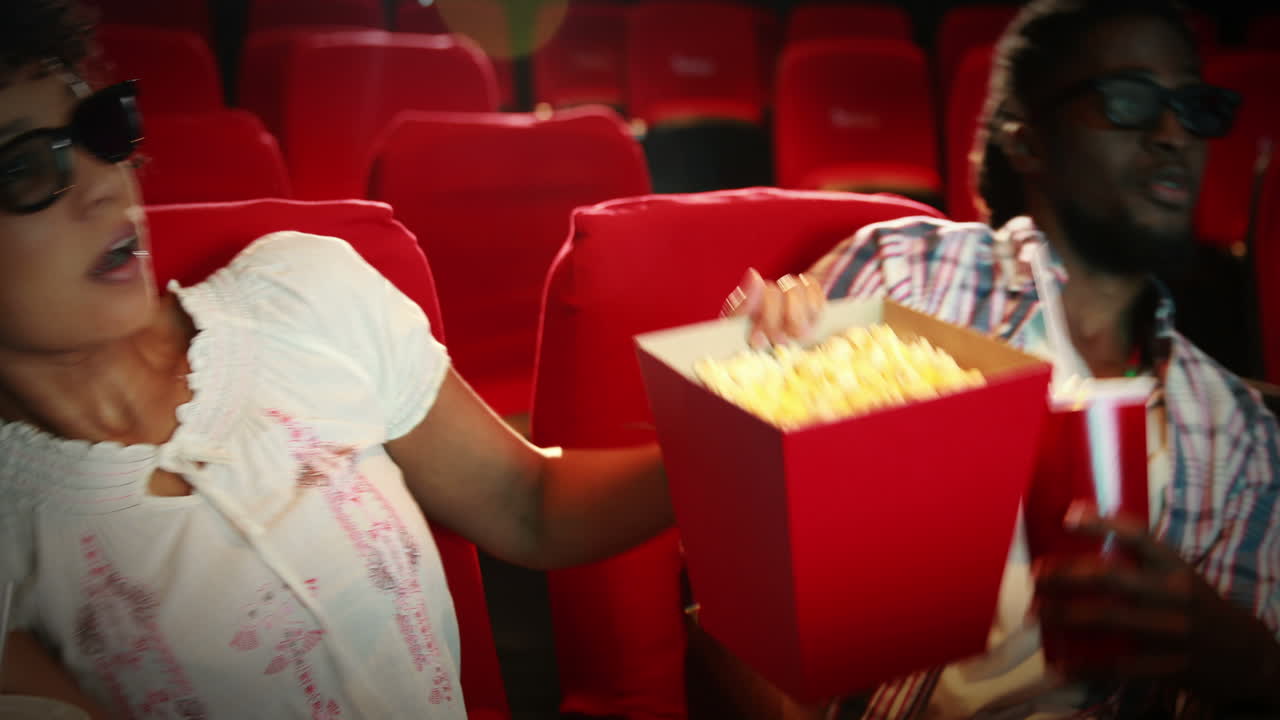 una pareja feliz viendo una película de miedo en 3d.