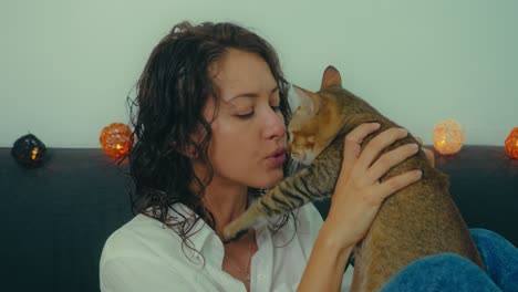 woman cuddling her cat on a sofa