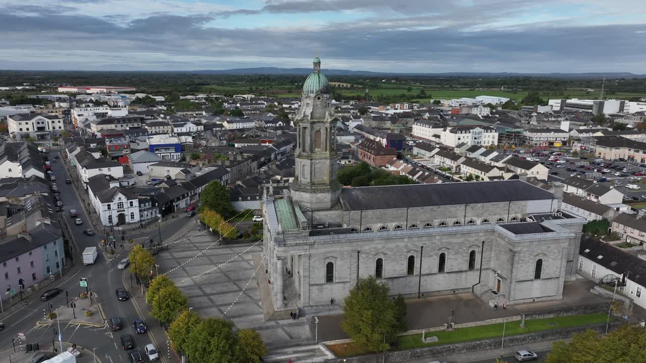 St Mel's Cathedral, Longford Town, County Longford, Ireland, September 2024. Drone orbits clockwise descending slowly towards the front of the restored Catholic church with communiting pedestrians.